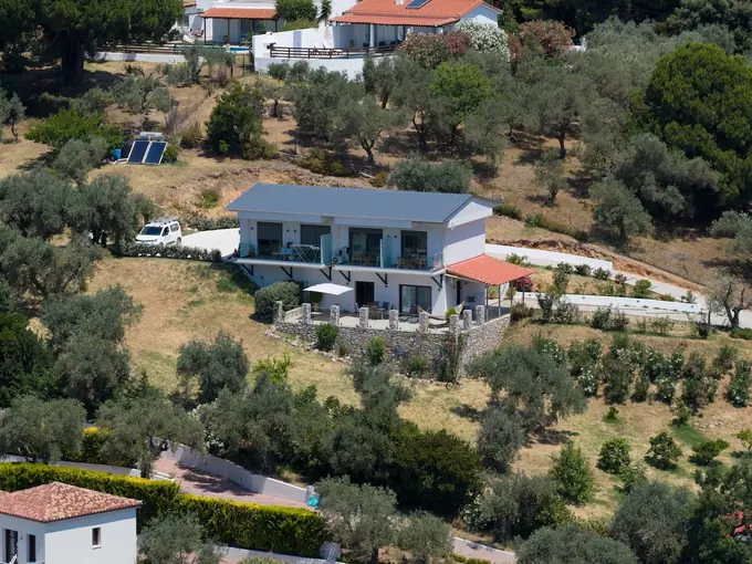 Close aerial view of Melina and its olive-tree plot