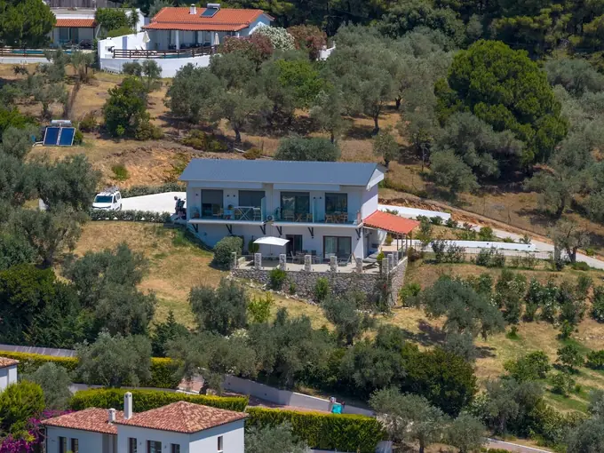 Aerial view of the building with its solar panels and parking