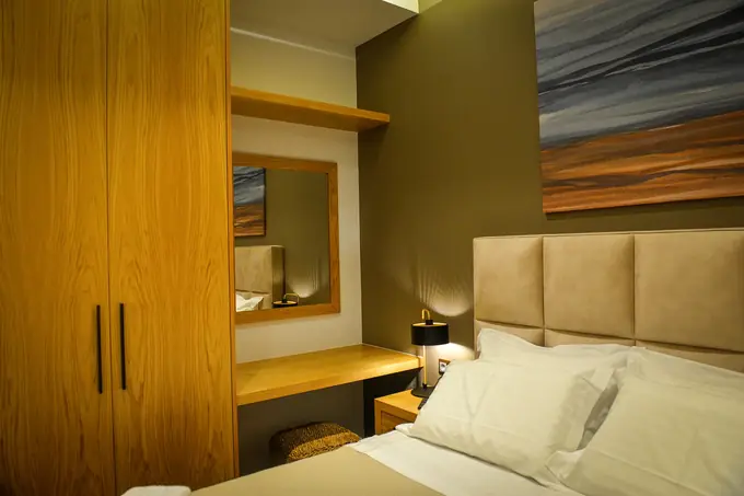 Bedroom with an oak wardrobe, desk and upholstered headboard
