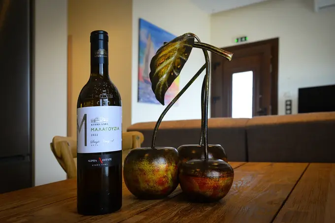 Wine and a bronze cherry sculpture on the dining table