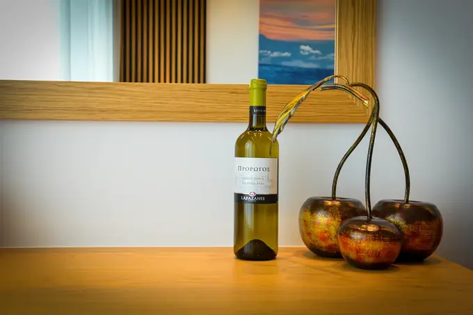 White wine and a bronze cherry sculpture on the oak desk