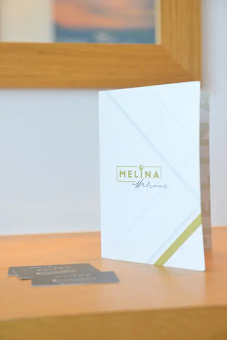The Melina welcome folder on the desk