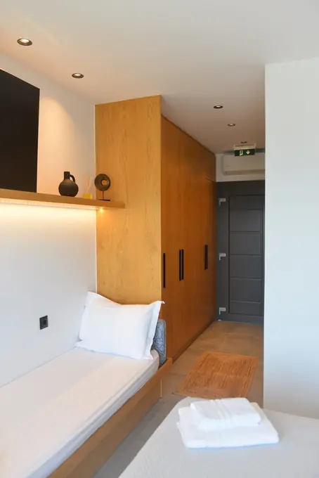 Single bed and oak wardrobe with lit shelves