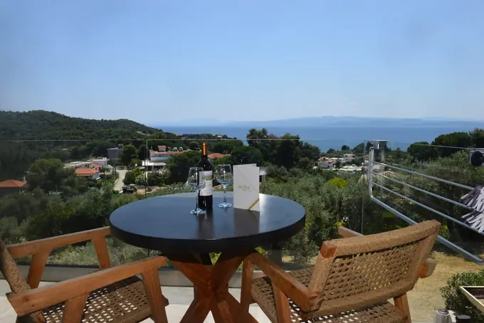 Terrace table and rattan chairs looking out to sea