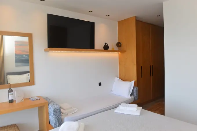 Bedroom with a wall-mounted TV and an oak wardrobe