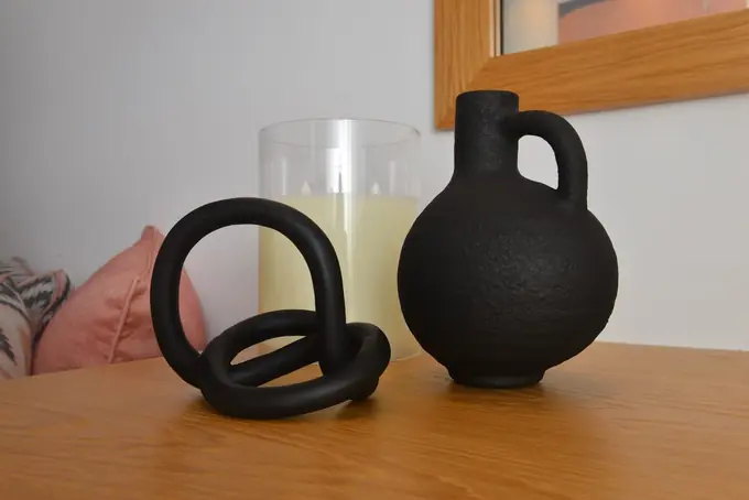 Black ceramic ornaments and a candle on the desk