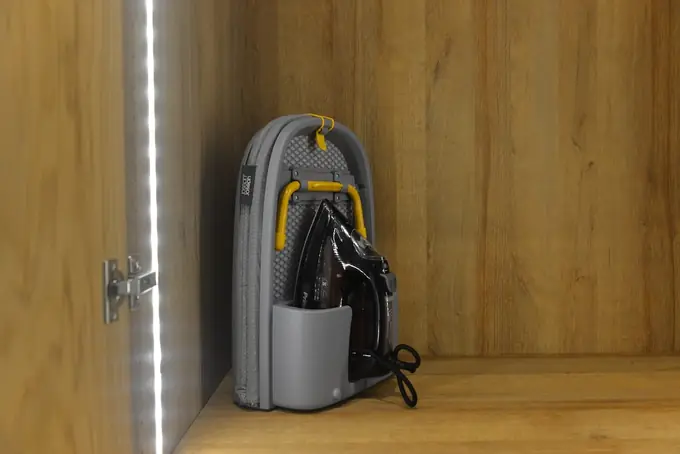 Iron and ironing board in the wardrobe