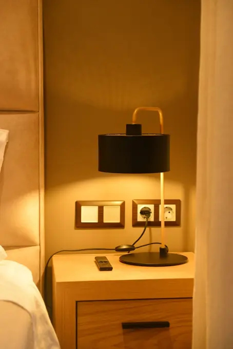Bedside lamp and switch panel in warm light